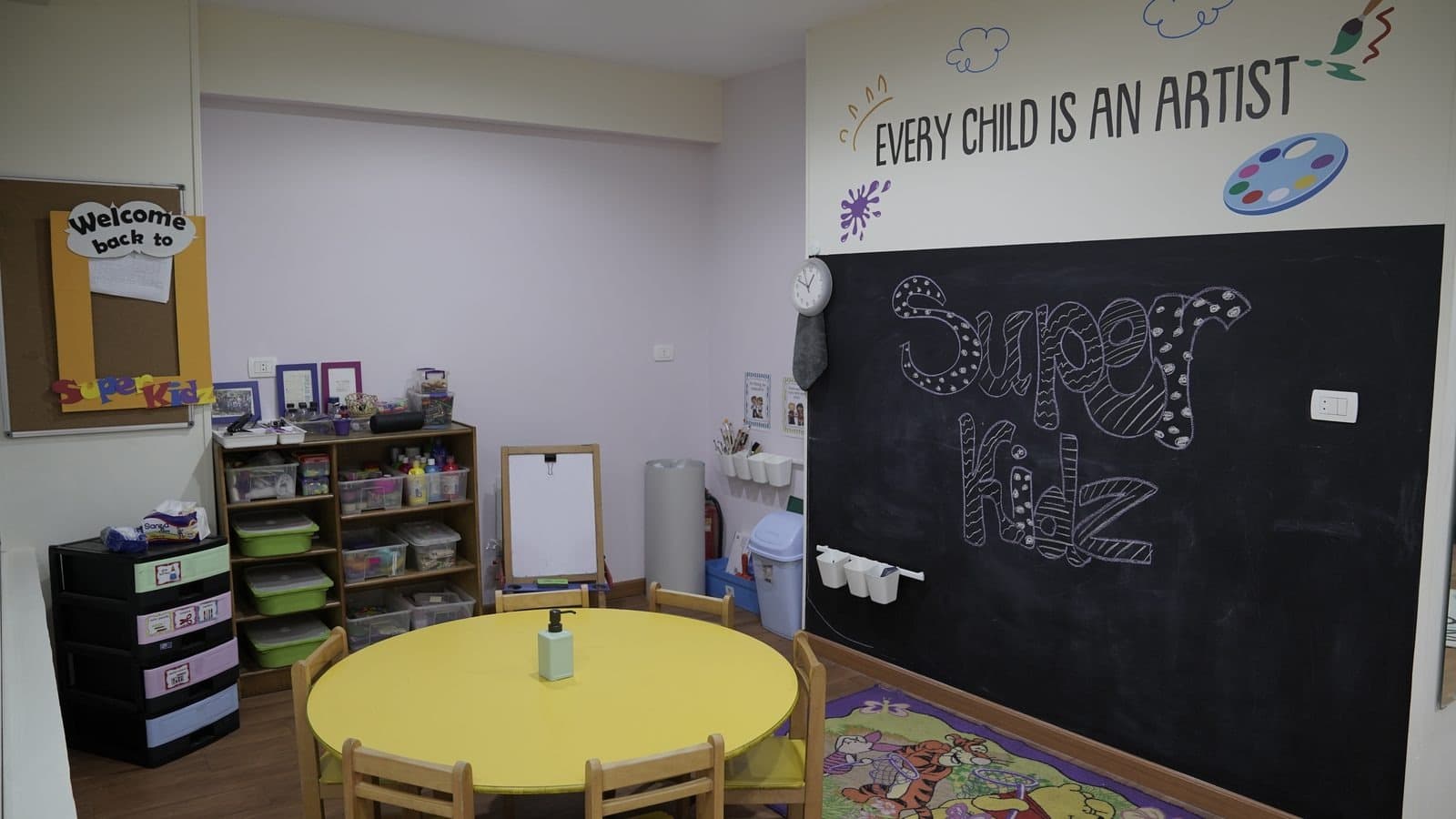 The art corner with its chalkboard wall reading ‘Every child is an artist’