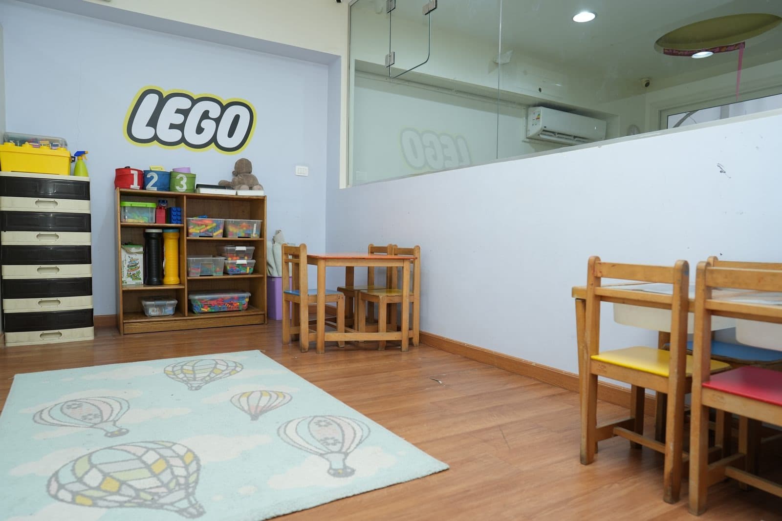 The LEGO corner, with the LEGO wall, building sets on open shelves and a work table