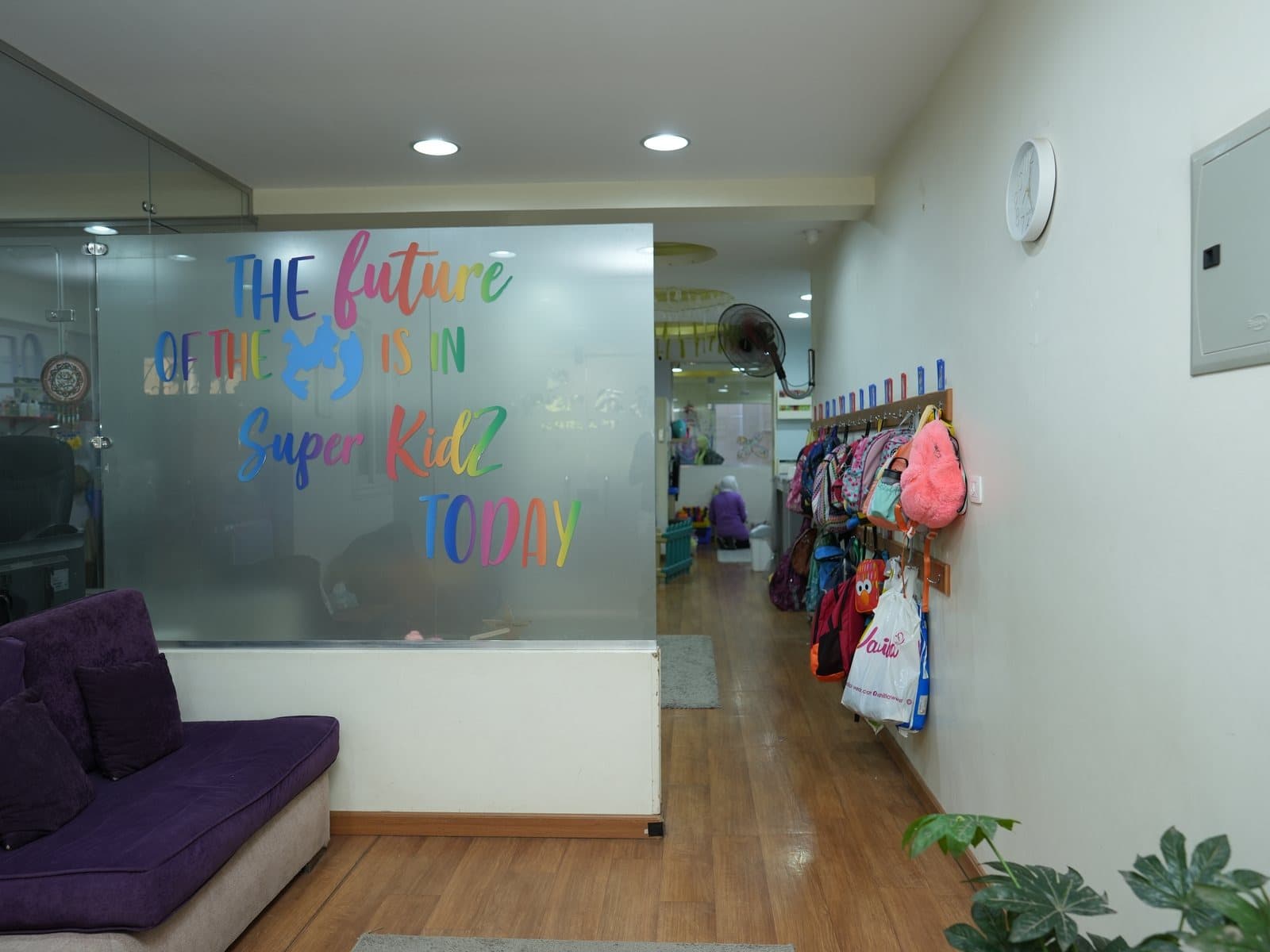 The reception area with a sofa and the welcome desk