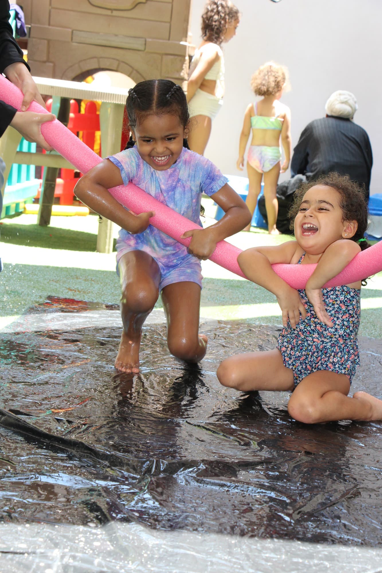 Super Kidz children posing together at the Splash Day Aloha photo wall