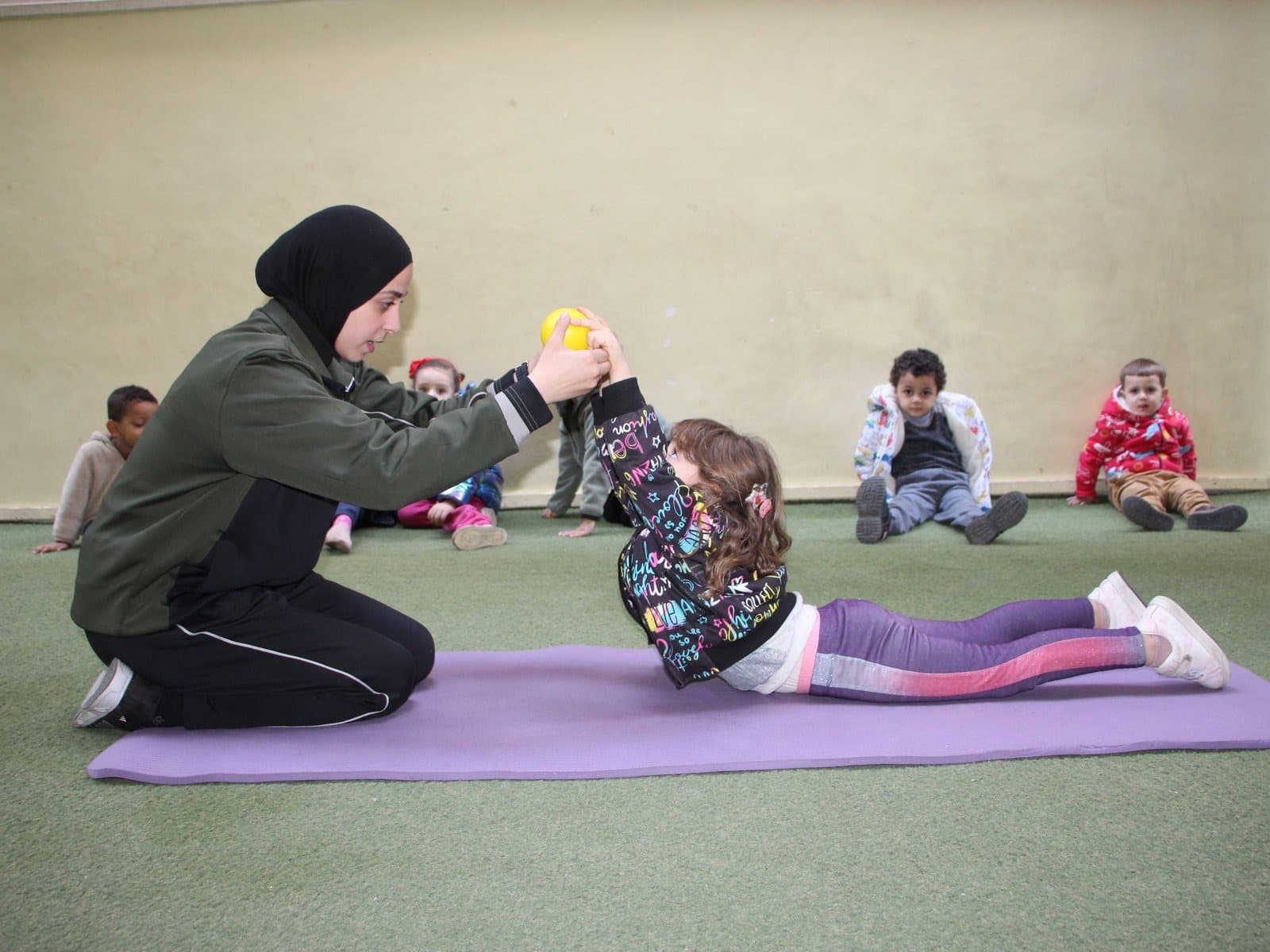 A gymnastics session on the play mat with one of the teachers