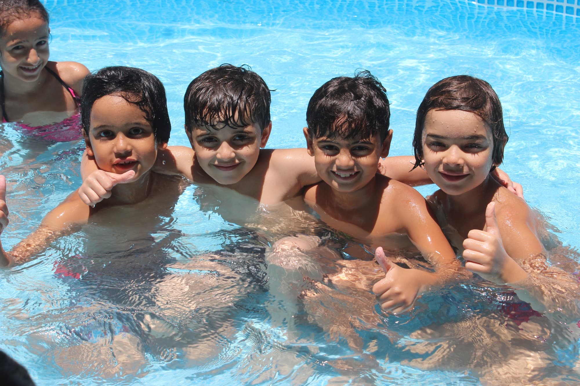 Children enjoying pool time during the Super Kidz camp programme