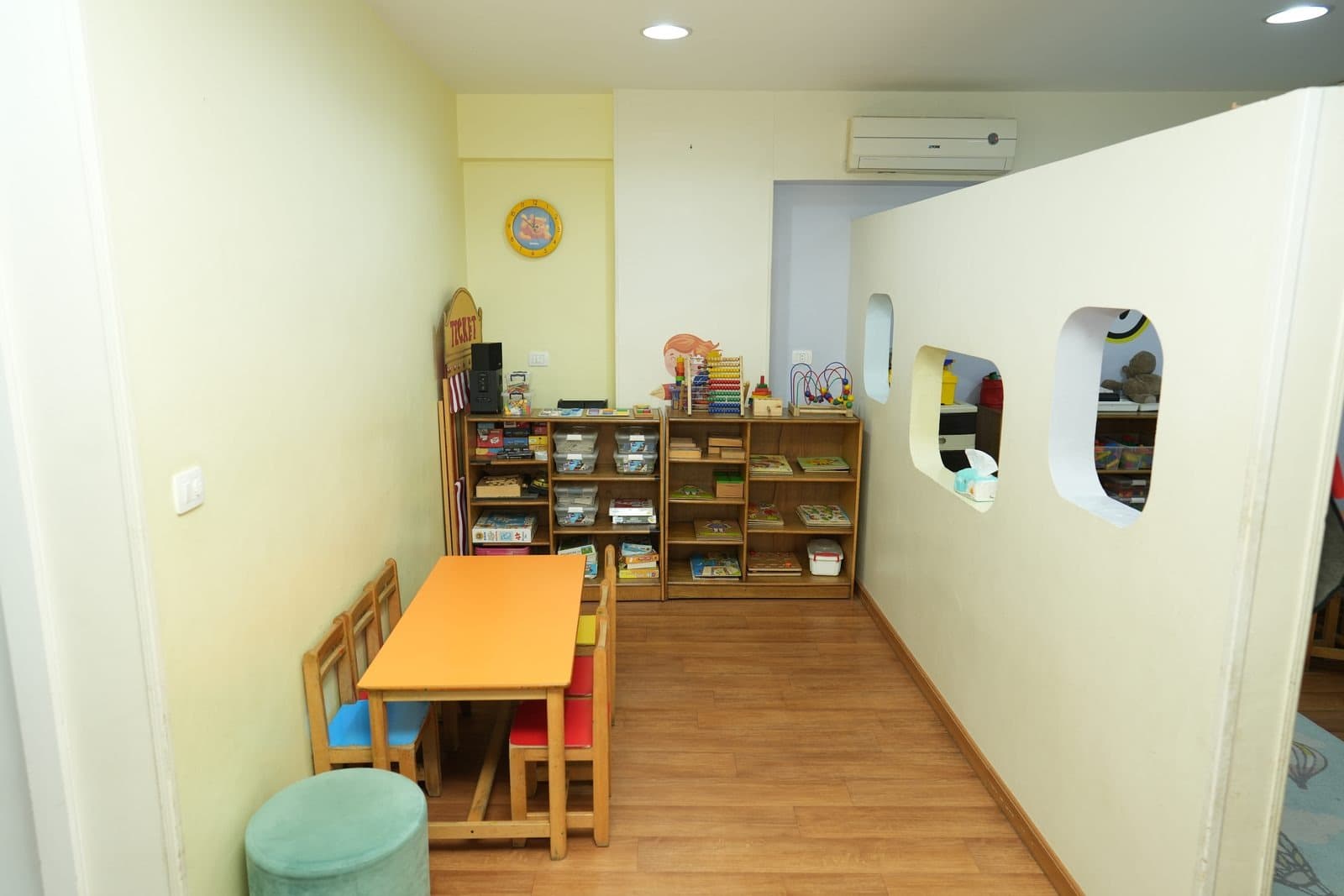 The puzzles and free-play corner, with puzzle boxes and games on low open shelving